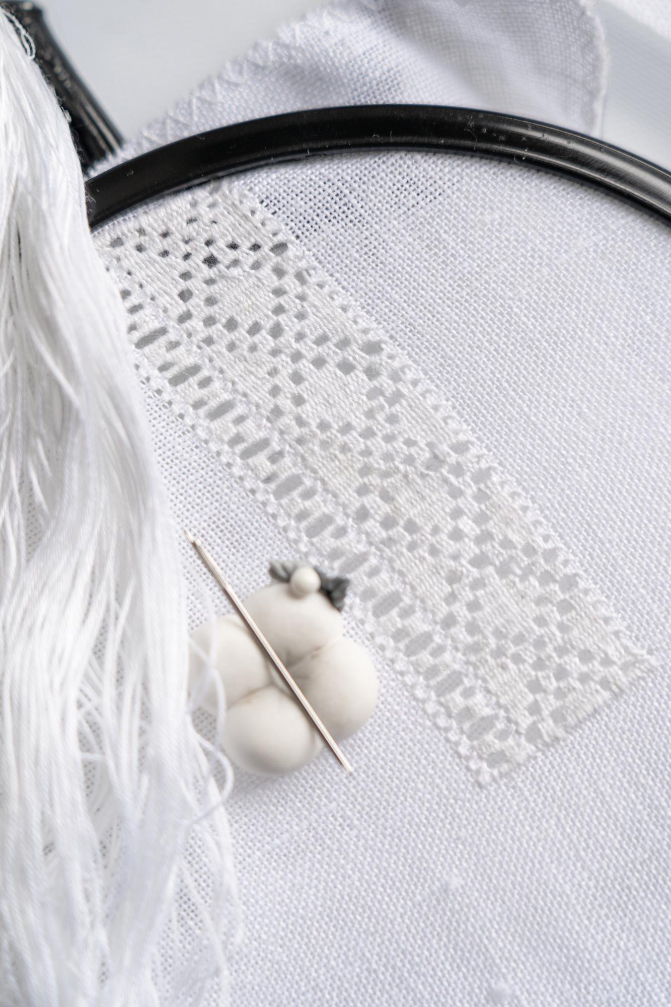 Close-up of satin stitch on pastel fabric
